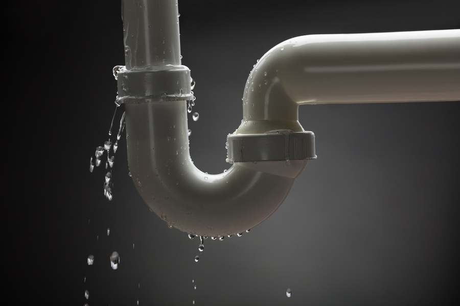 Leakage Of Water From Stainless Steel Pipe On Gray Background